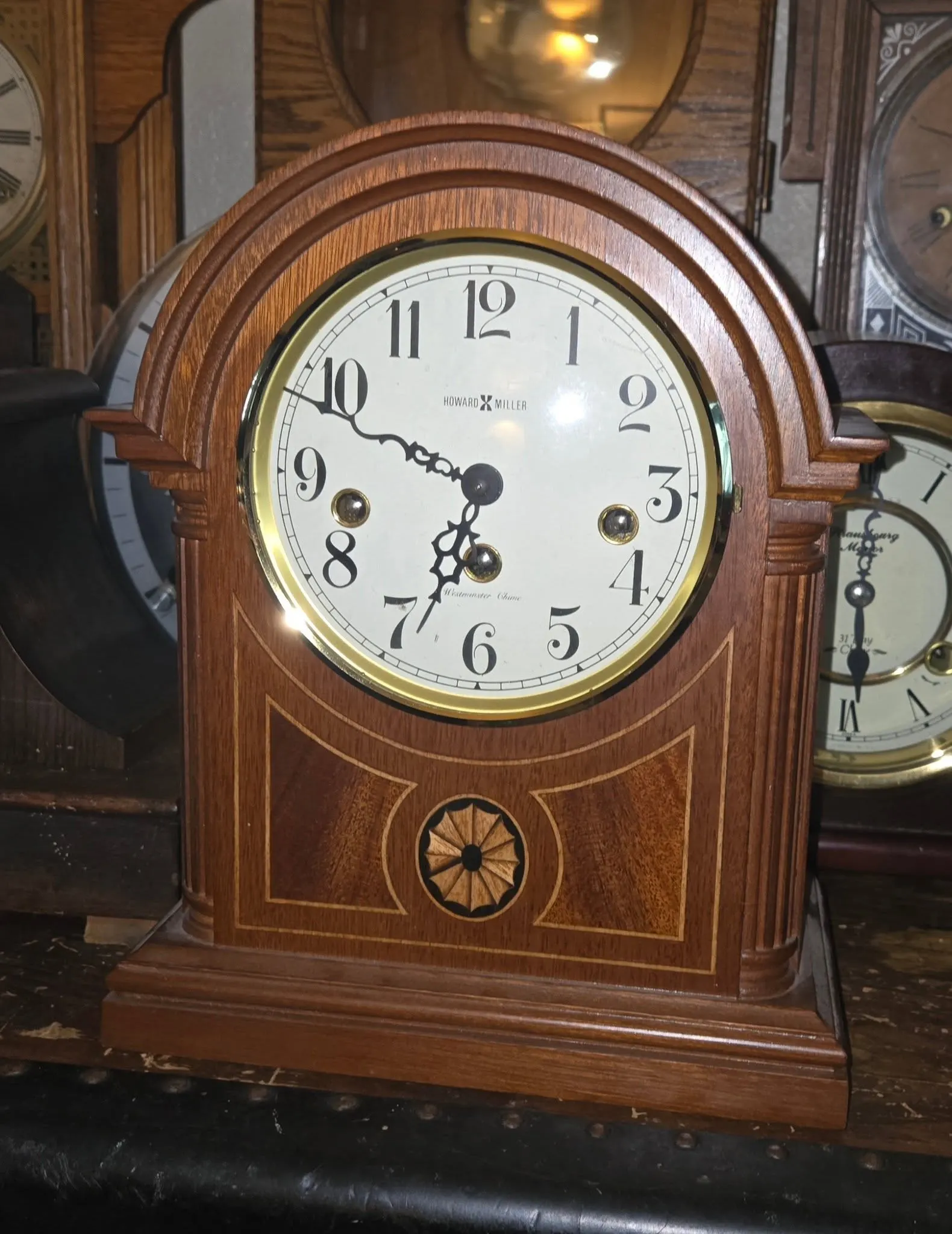Howard Miller barrel-top mahogany mantel clock with inlaid rosette detail